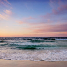 Winter sunrise scene with soft pastel colors in blue and pink at Jones Beach, Long Island, NY.